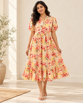 Adult Indian woman modeling the calf-length cream floral cotton dress, front view